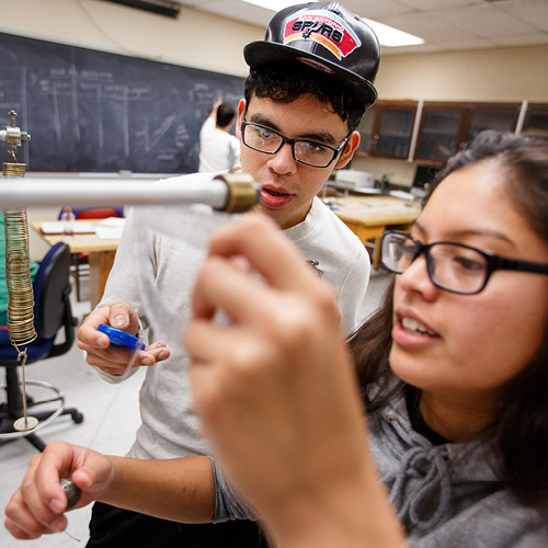 two SF State students creating reviewing a lab sample.