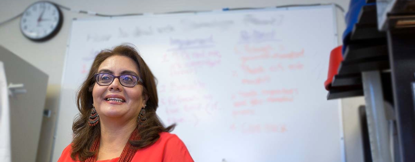Leticia Márquez-Magaña standing in front of a whiteboard